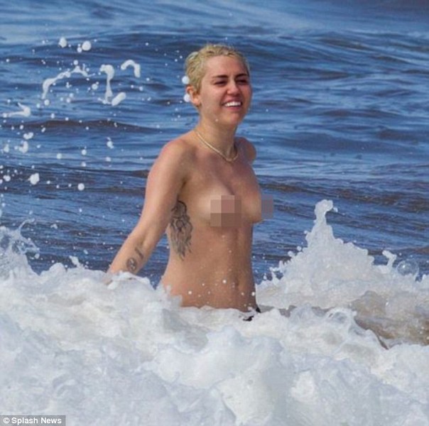 Miley Cyrus topless in the ocean with boyfriend Patrick Schwarzenegger 